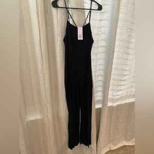 Cotton strappy back black romper with pockets. Small